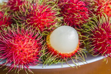 rambutan on white plateの写真素材