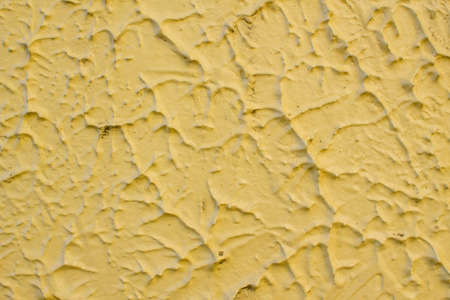 yellow cement wall texture backgroundの写真素材