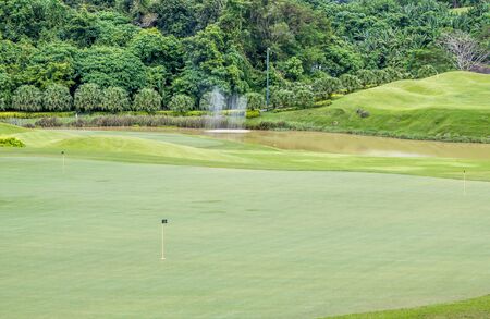 green golf course with flag poleの写真素材