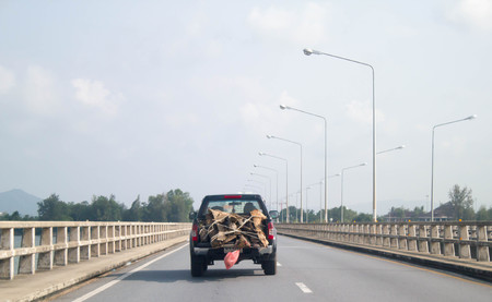 wood on pick up truck on the road of Thailandの写真素材