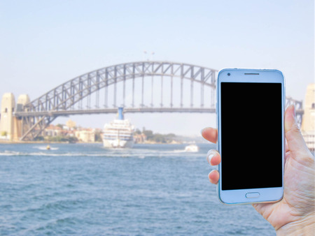 hand use smart phone to take photo the Sydney Harbour Bridgeの写真素材