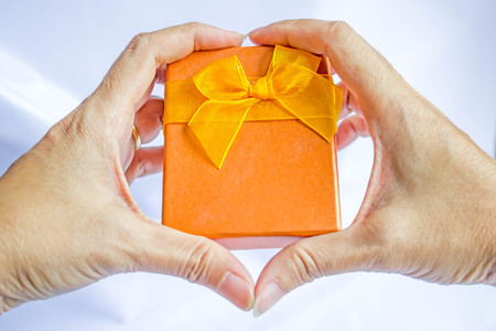 gift box in hand heart shapeの写真素材