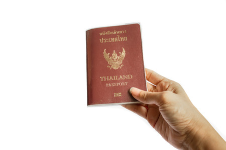 Hand holding Thailand passport isolated on white backgroundの写真素材