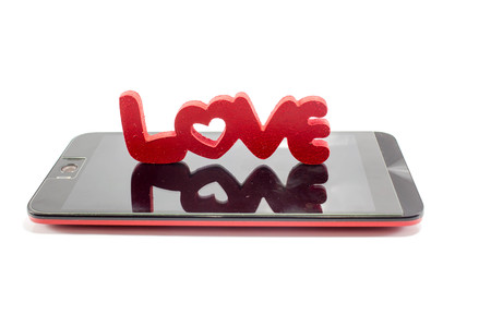 love word on smart phone isolated on white background: concept photo of love phoneの写真素材