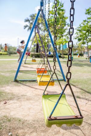 old playground swings in the parkの写真素材