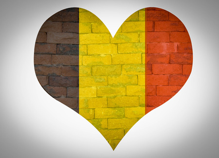 Belgium flag on  an old retro red brick backgroundの写真素材