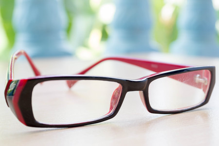 red glasses on wood background