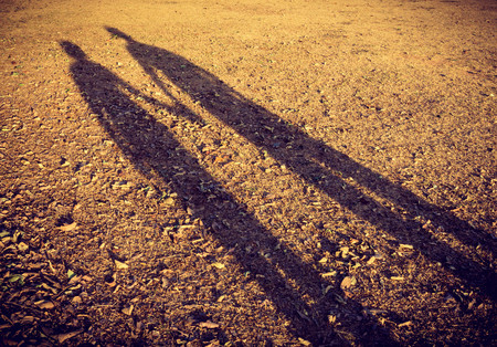 lovers shadow on the dried grasses in the park