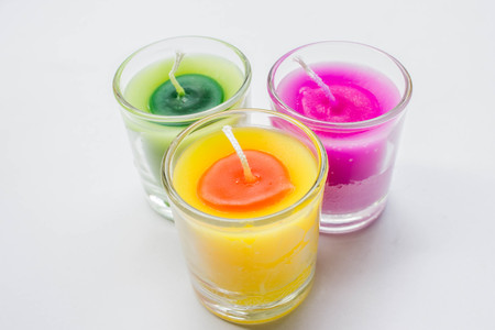 aromatherapy colorful candle in glass on white backgroundの写真素材