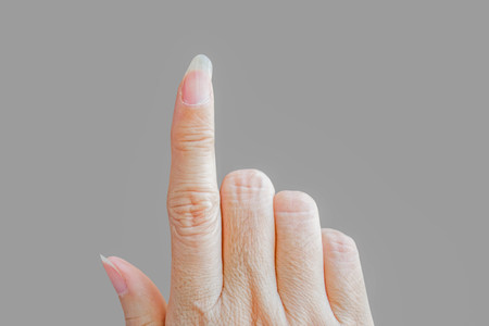 unhealthy nail (bend and brittle isolated on gray backgroundの写真素材