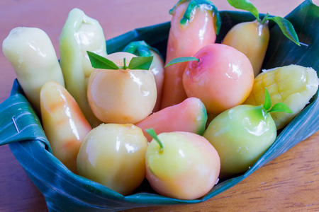 kanom Look Choup  : Thai traditional dessert made from green been, coconut milk, sugar and jelly in fruit shape put on cup made from banana leafの写真素材