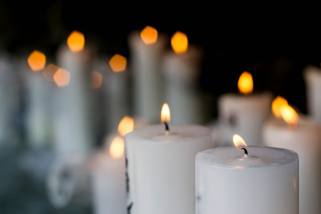 close up of white candle light in the darkの写真素材