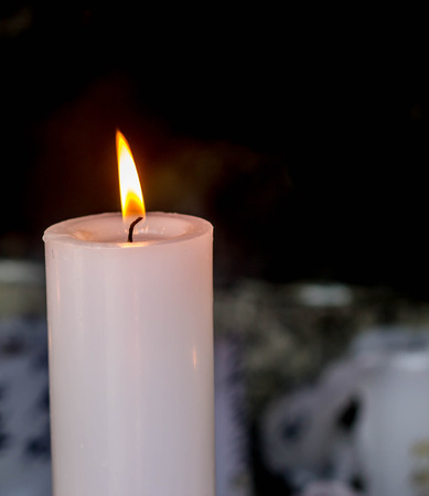 close up of white candle light in the darkの写真素材