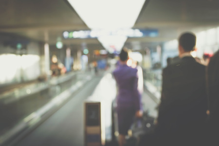 blur motion of flight crew on escalator in the airportの写真素材
