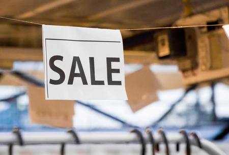 sale banner on white paper at the shop
