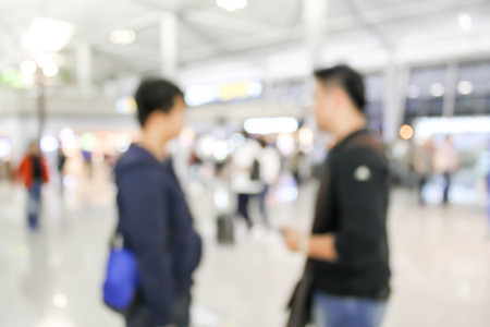blurred of two men talking at the airportの写真素材