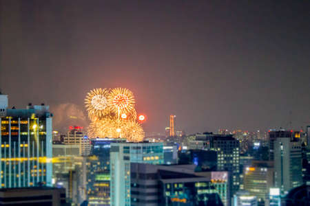 fireworks over city building at nightの写真素材