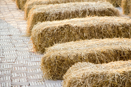 stack of dried straw on brick floorの写真素材