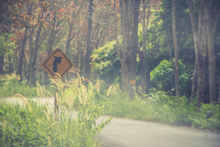 road on moutain with turn right sign poleの写真素材