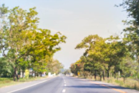 abstract motion blurred of road with green treeの写真素材