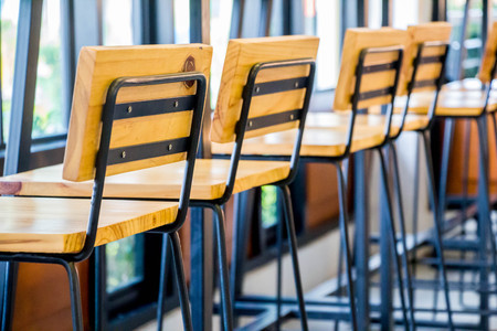 row of modern wood chair in restaurantの写真素材