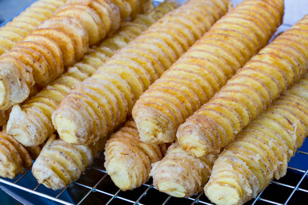 fried potato spiral on stickの写真素材