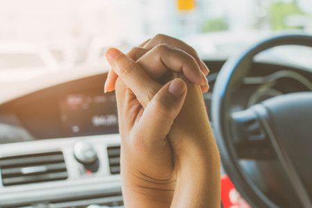 loving couple holding hand in carの写真素材