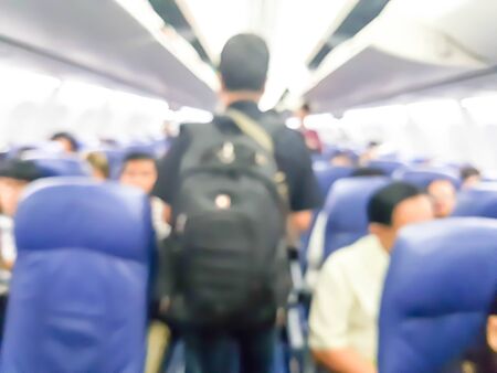 blurred photo of passenger with backpack walking in the airplaneの写真素材