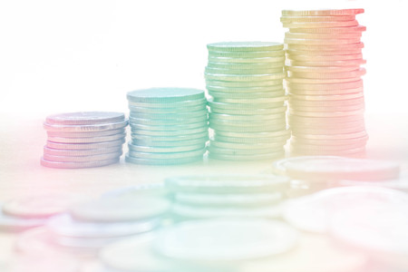 row of coins on white background with gradient filterの写真素材