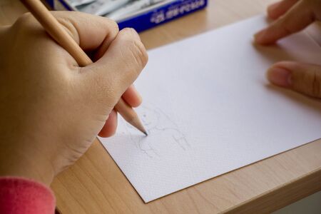 left hand drawing cartoon on paper