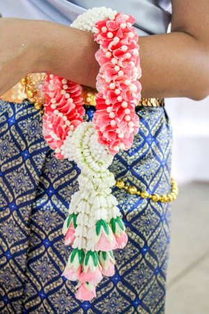 beautiful garland on Thai woman hand in traditional culture suitの写真素材