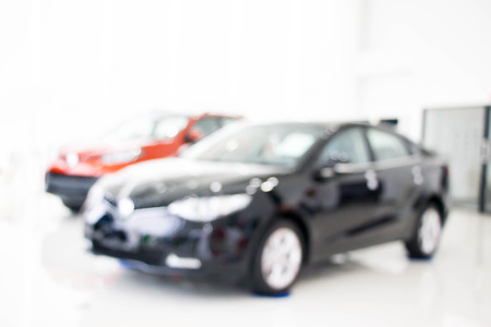 blurred back of new car display for sale in showroomの写真素材