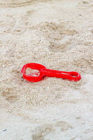 red sand scoop on the sandの写真素材