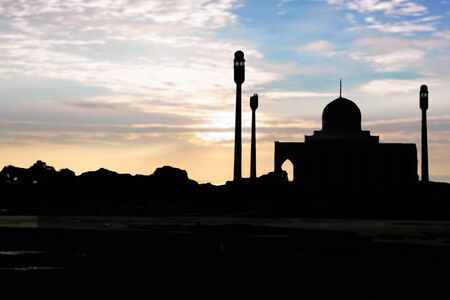 Ramadan Kareem :  Silhouette of Mosque (Masjid) on city  blur bokeh lightの写真素材