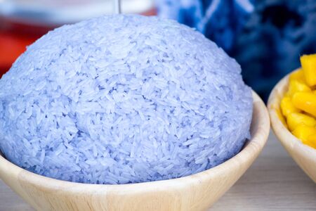 sticky rice in blue color (from butterfly pea flower) eat with coconut icecream or mangoの写真素材