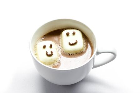 cute marshmallow smile face on hot coffee in white cupの写真素材