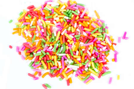 pile of colorful sprinkles for bakery isolated on white background