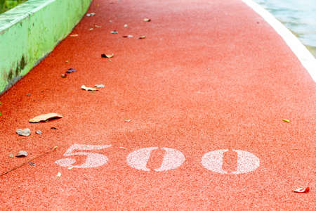 number on red alphalt walkway in the park