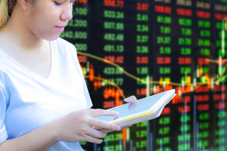 Asian teenager using tablet for invest in stock market