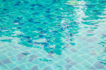 background texture of blue water in swimming pool with sunlightの写真素材