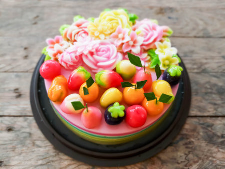 kanom Look Choup on coconut jelly cake: Thai traditional dessert deletable imitation fruits made from green been, coconut milk, sugar and jelly in fruit shape (look like Marzipan)の写真素材