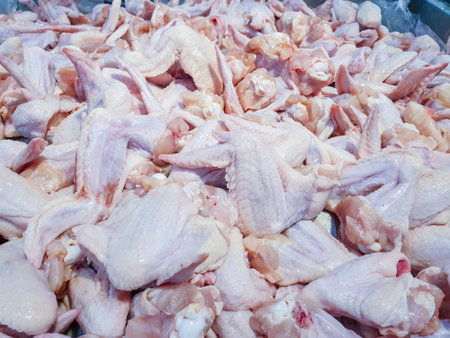 chicken wings. Pile of raw chicken wings in a market. Uncooked chicken wings. Raw chicken meatの写真素材