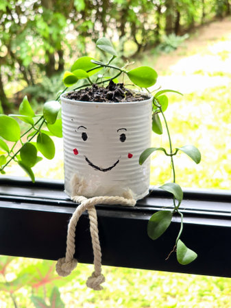 decorated outdoor gardening with cute recycled can plant potの写真素材