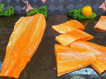 fresh salmon meat displayed on black shelf in the super marketの写真素材