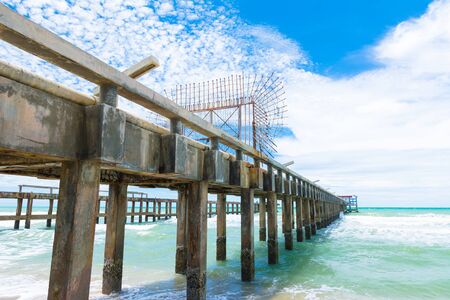 Long bridge on the beach with blue skyの写真素材