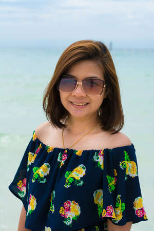 close up portrait of young woman walking by the seaの写真素材