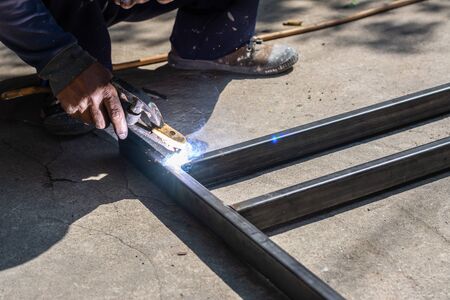 The welder is working on welding. Sparkling and Smokeの写真素材