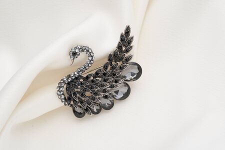Silver brooch shaped like a swan with small diamonds, isolated on white background. Women Accessoriesの写真素材