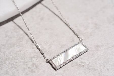 Pendant with a piece of marble in the middle, framed with crystals. Women accessoriesの写真素材
