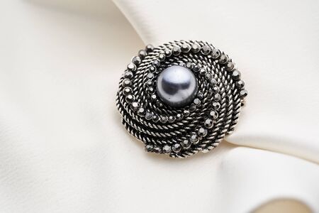 Brooch with small diamonds and black pearl,  isolated on white background. Women Accessoriesの写真素材